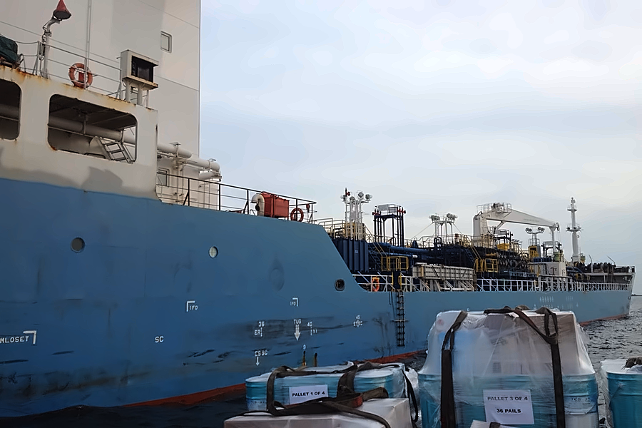 Palletised stores on a supply boat alongside a tanker